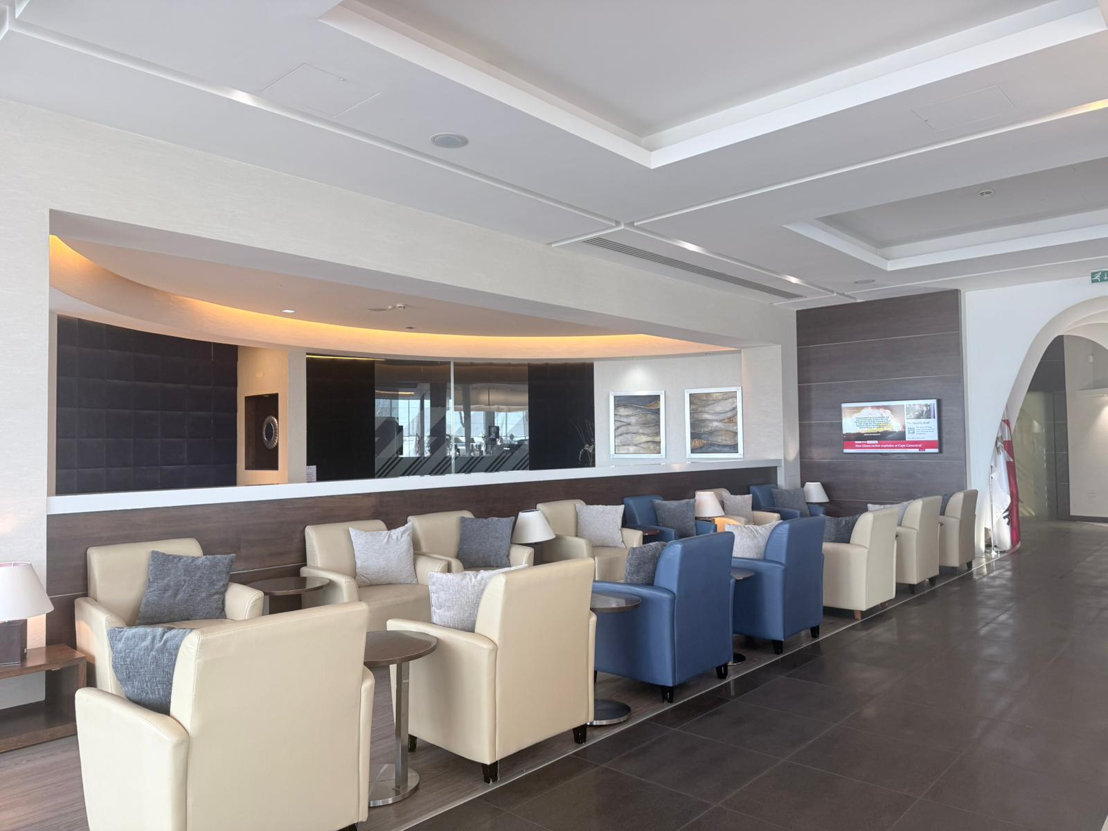 Seating area and panoramic runway view inside the Gulf Air lounge at Terminal 4 London Heathrow