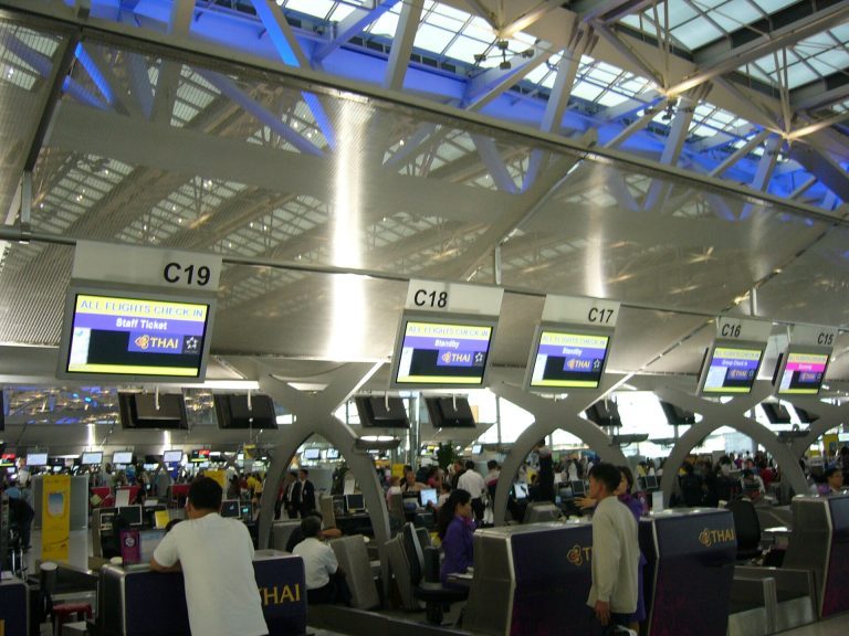 Passengers at airline check-in counters at Bangkok Suvarnabhumi Airport