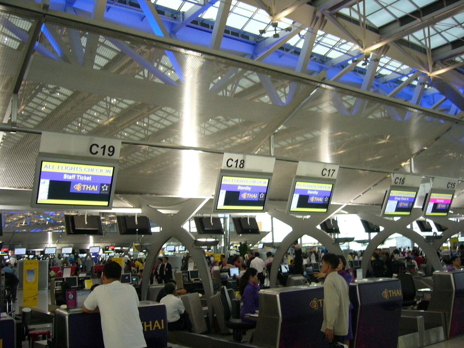 Passengers at airline check-in counters at Bangkok Suvarnabhumi Airport