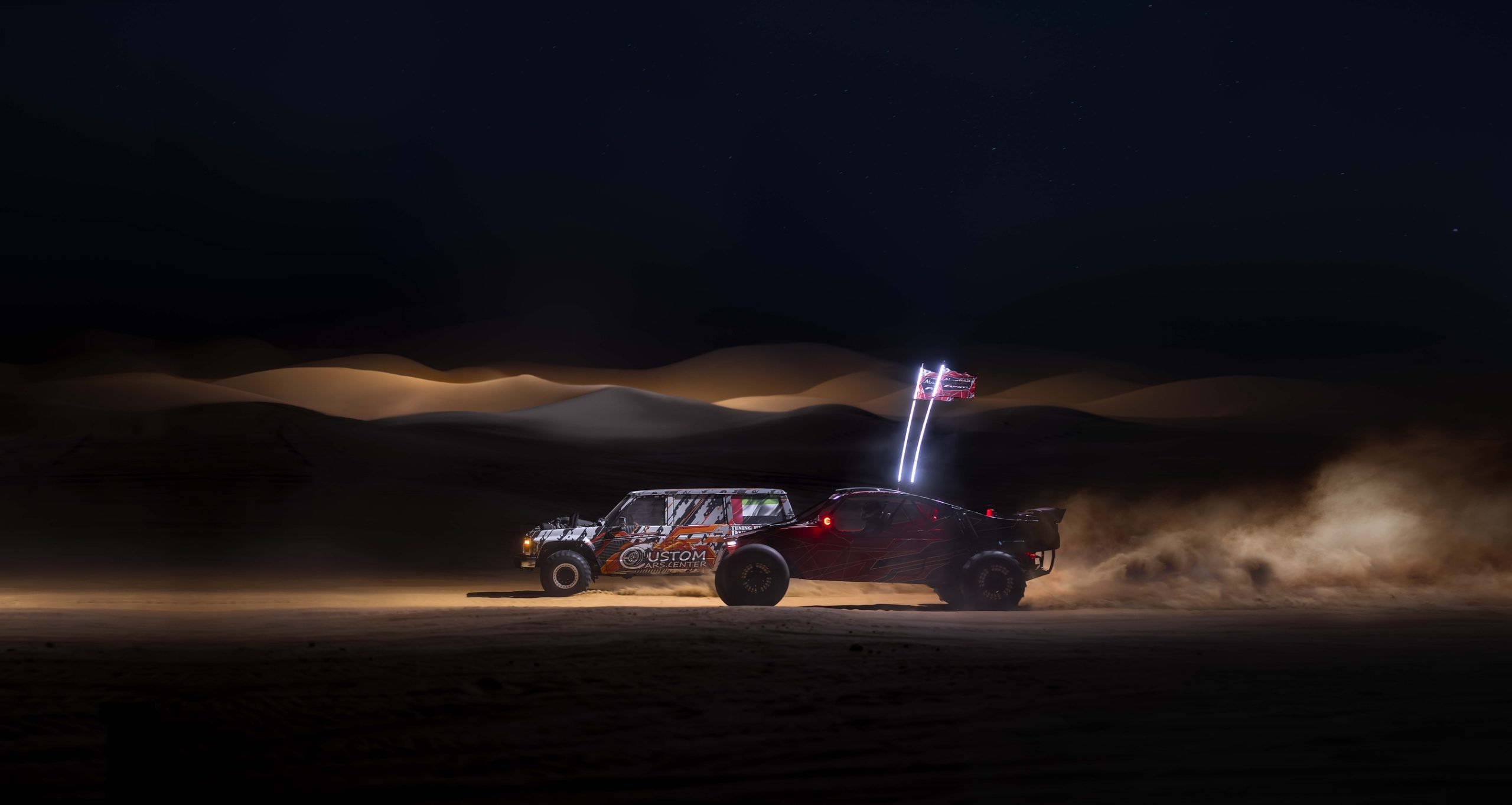Liwa International Festival promotional image showing desert motorsport at night