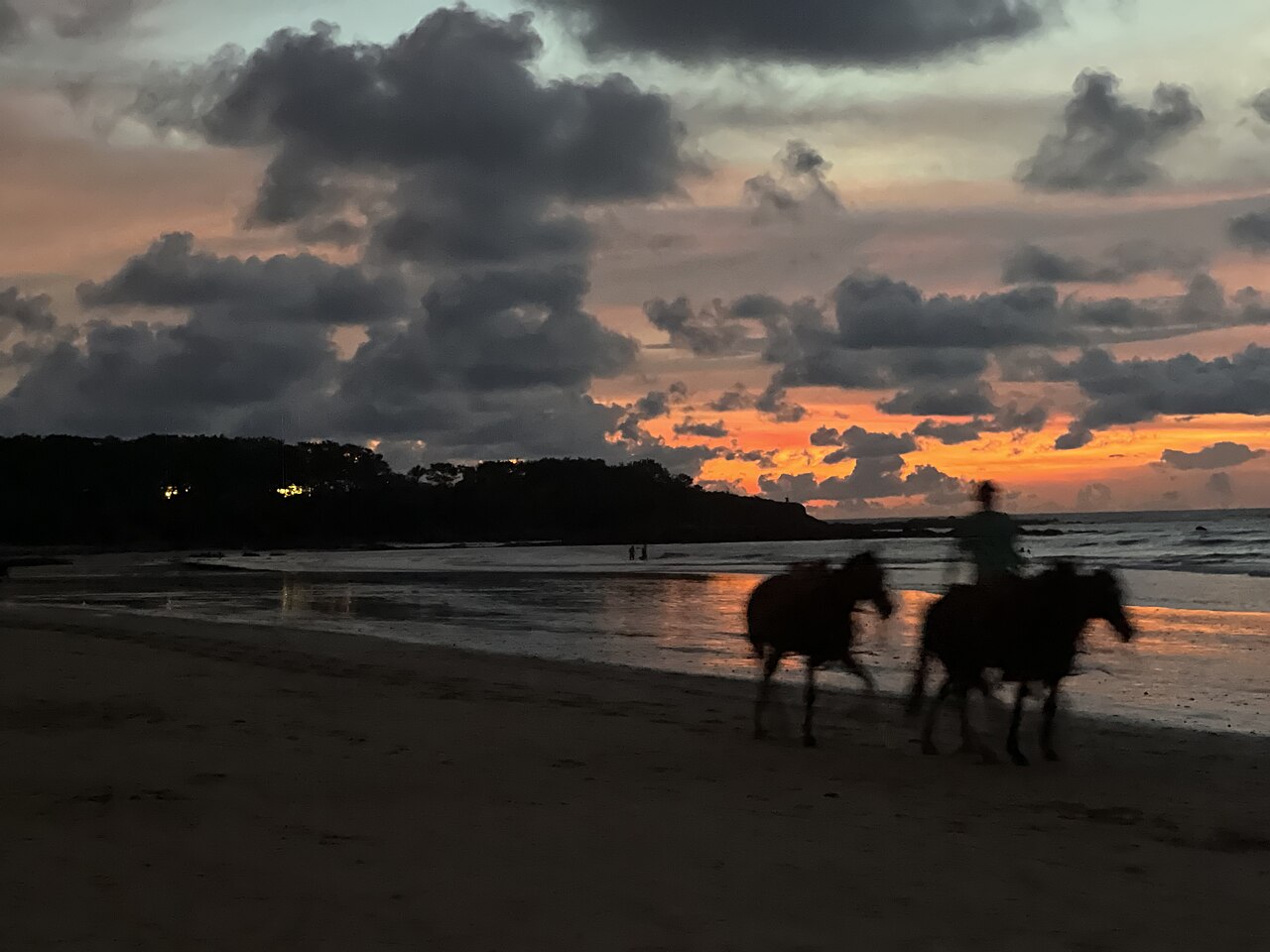 Riders on a Guanacaste beach on Costa Rica's Pacific coast at sunset