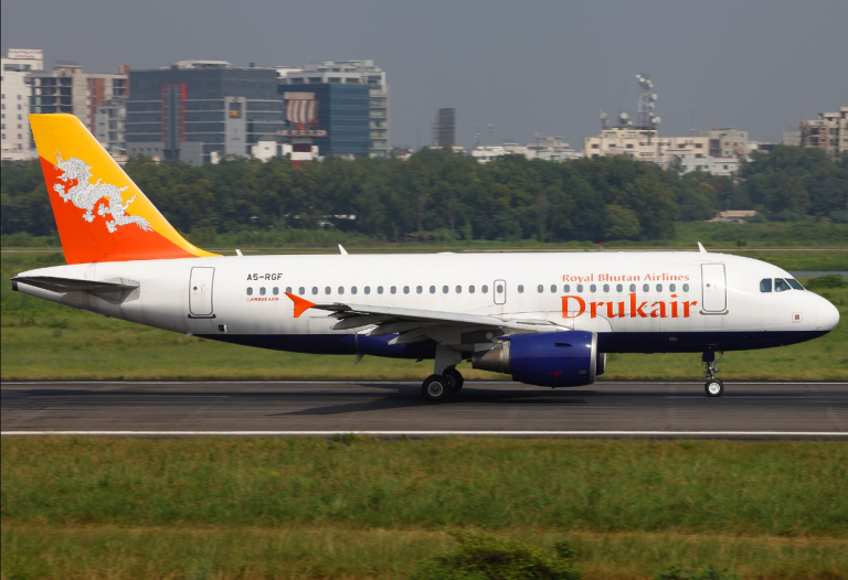 Drukair Airbus A319 taking off from an airport runway