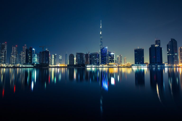 Dubai skyline at night with Burj Khalifa reflected in the water