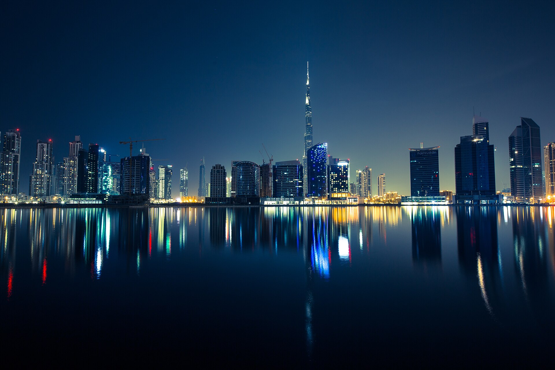 Dubai skyline at night with Burj Khalifa reflected in the water