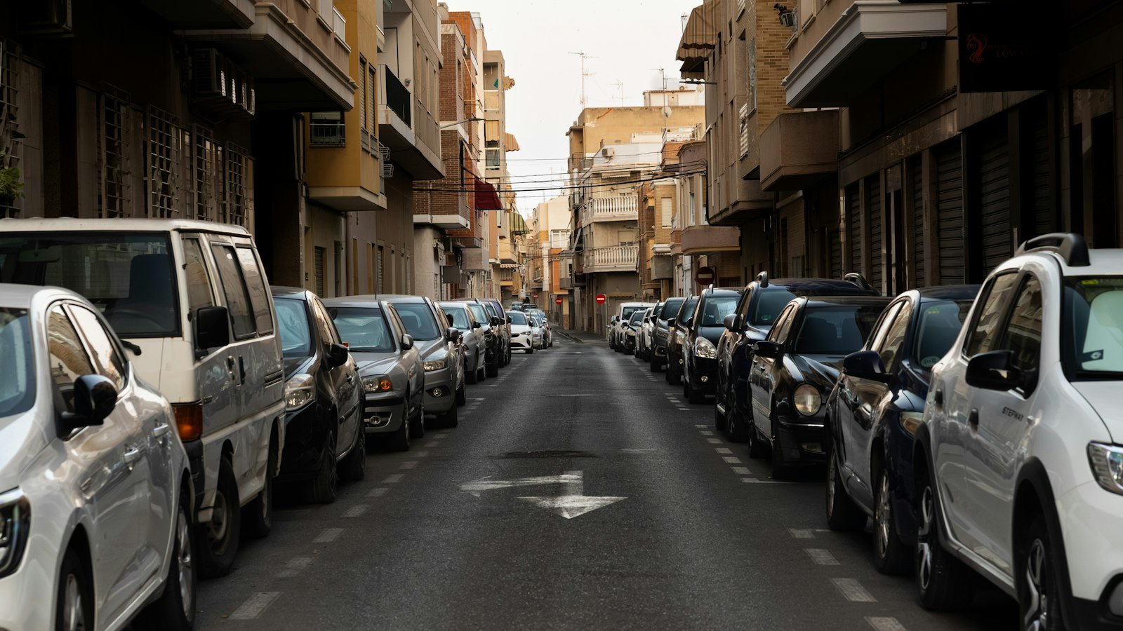 Cars parked along a narrow European street