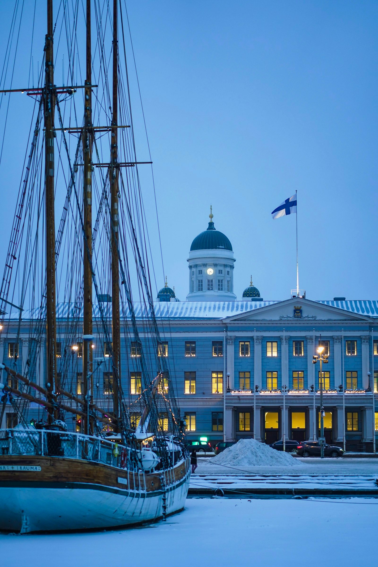 Boat docked in front of a large building in Helsinki