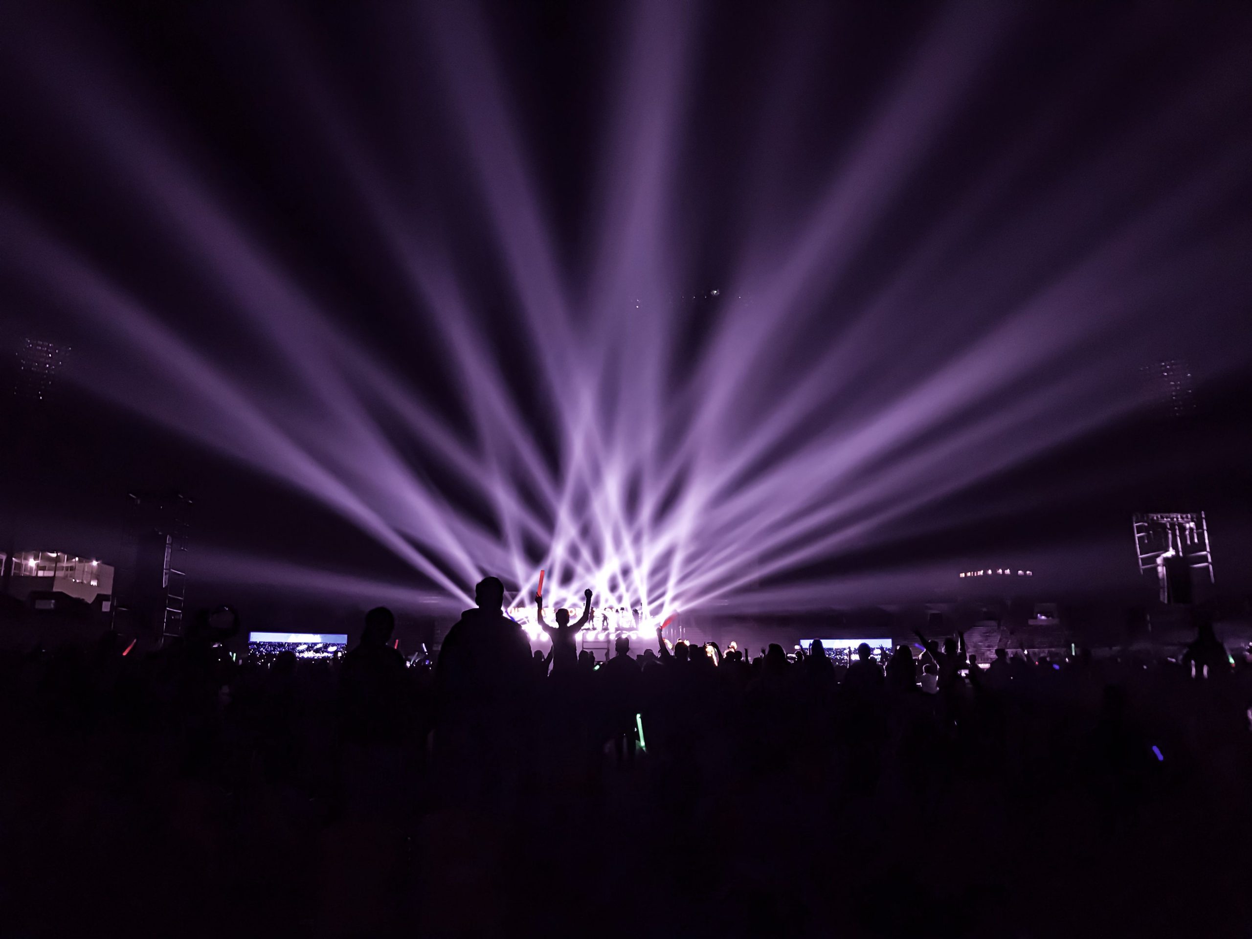 Concert audience under colourful stage lights
