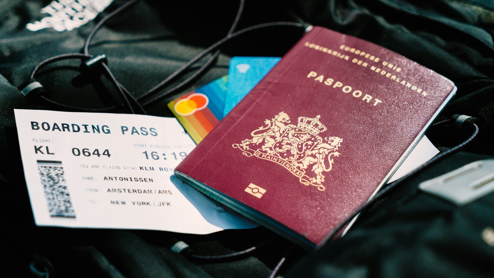 Passport and boarding pass resting on a bag