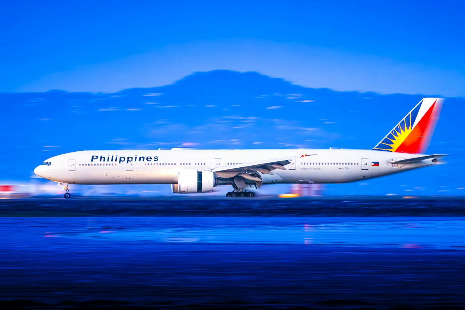 Philippine Airlines aircraft on the runway at dusk
