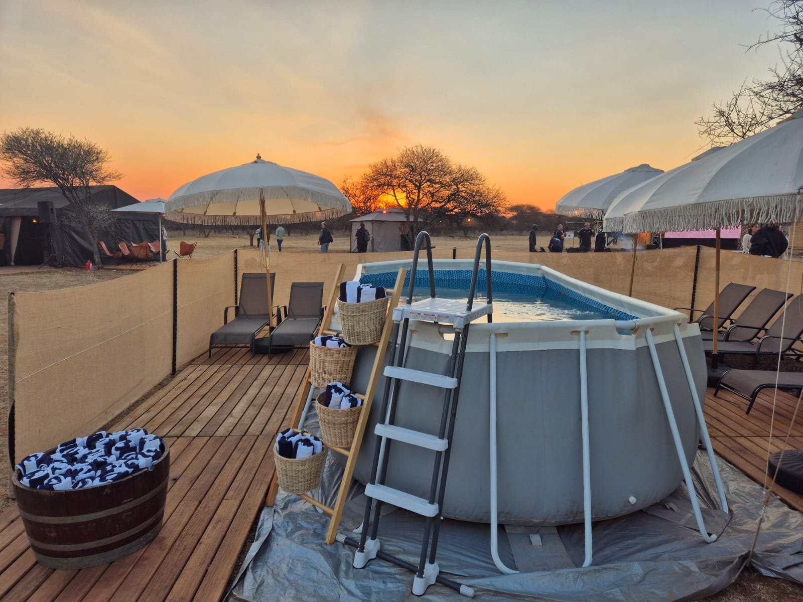 Plunge pool and sun loungers at sunset at a Chiefs Tented Camps site