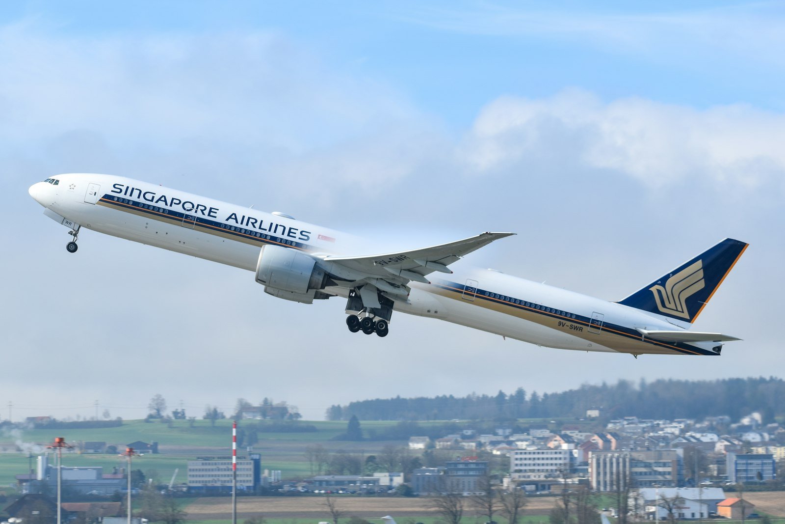 Singapore Airlines Airbus A350 taking off against a blue sky